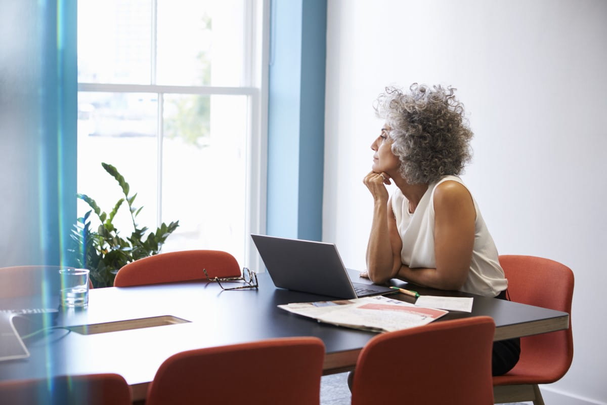 Woman looking out window in office