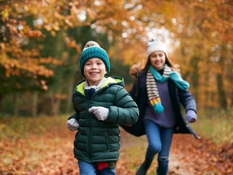Children running in a forest