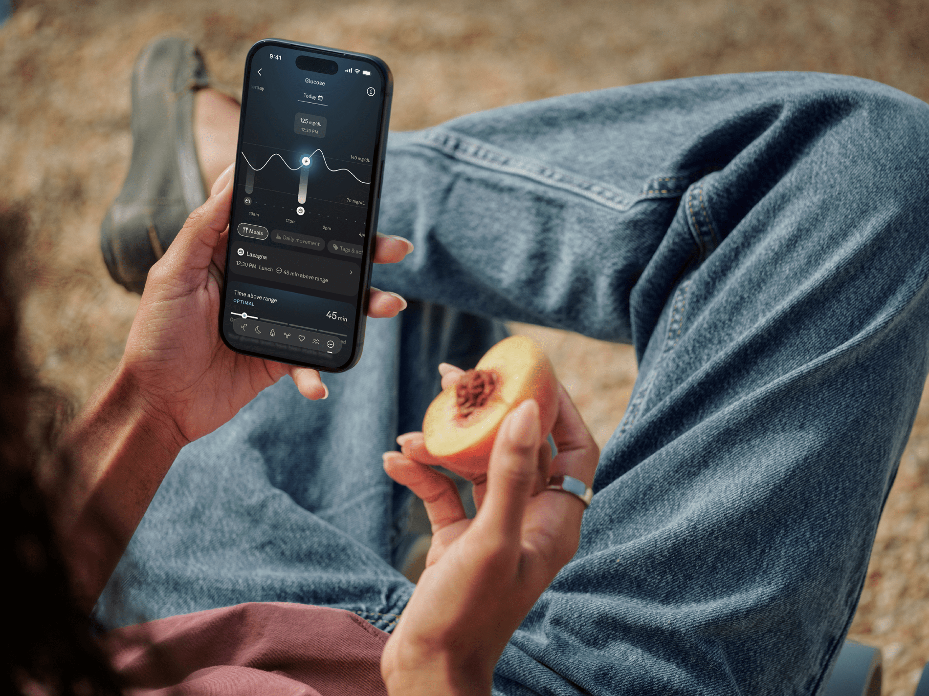 Lady looking at activity tracker wearing Oura Ring 5