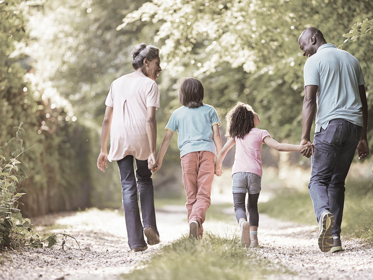 family holding hands walking outside