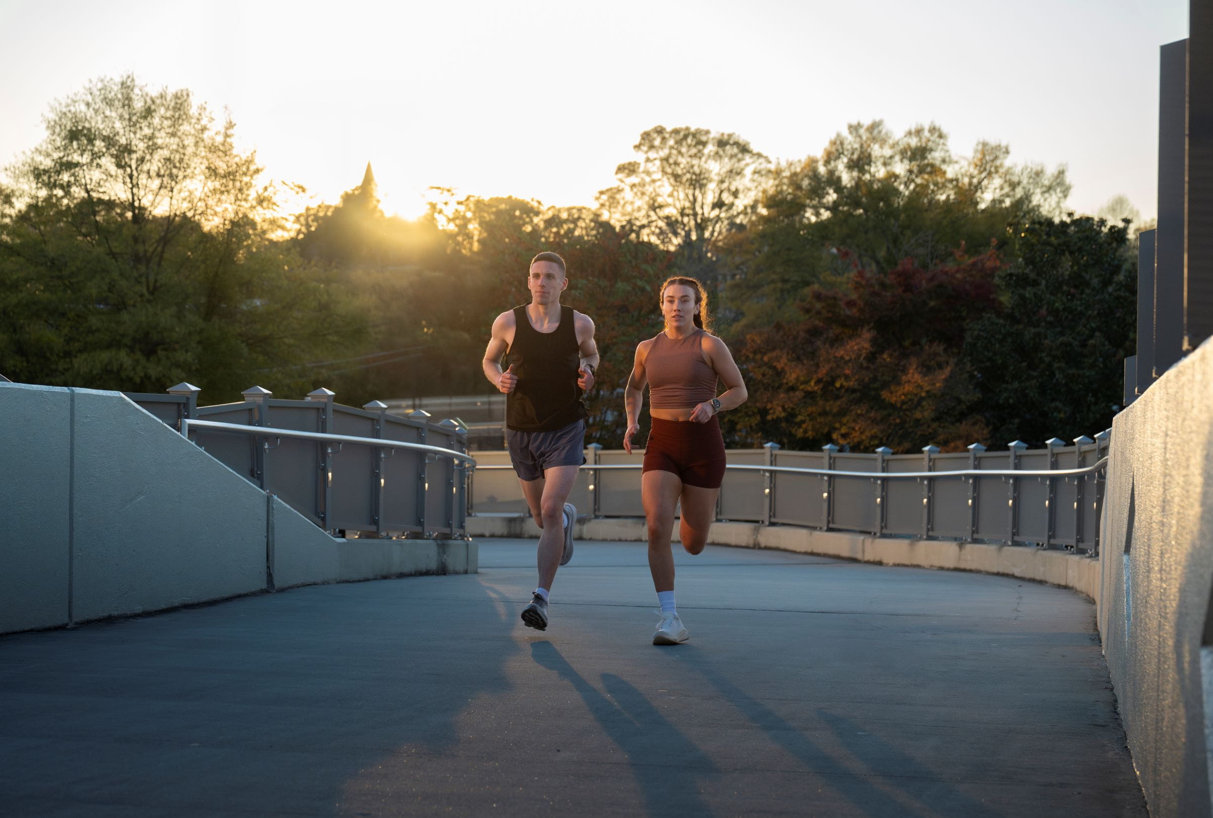Two people running, with Garmin