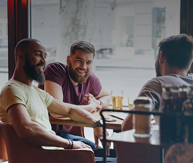 Men talking around pub table