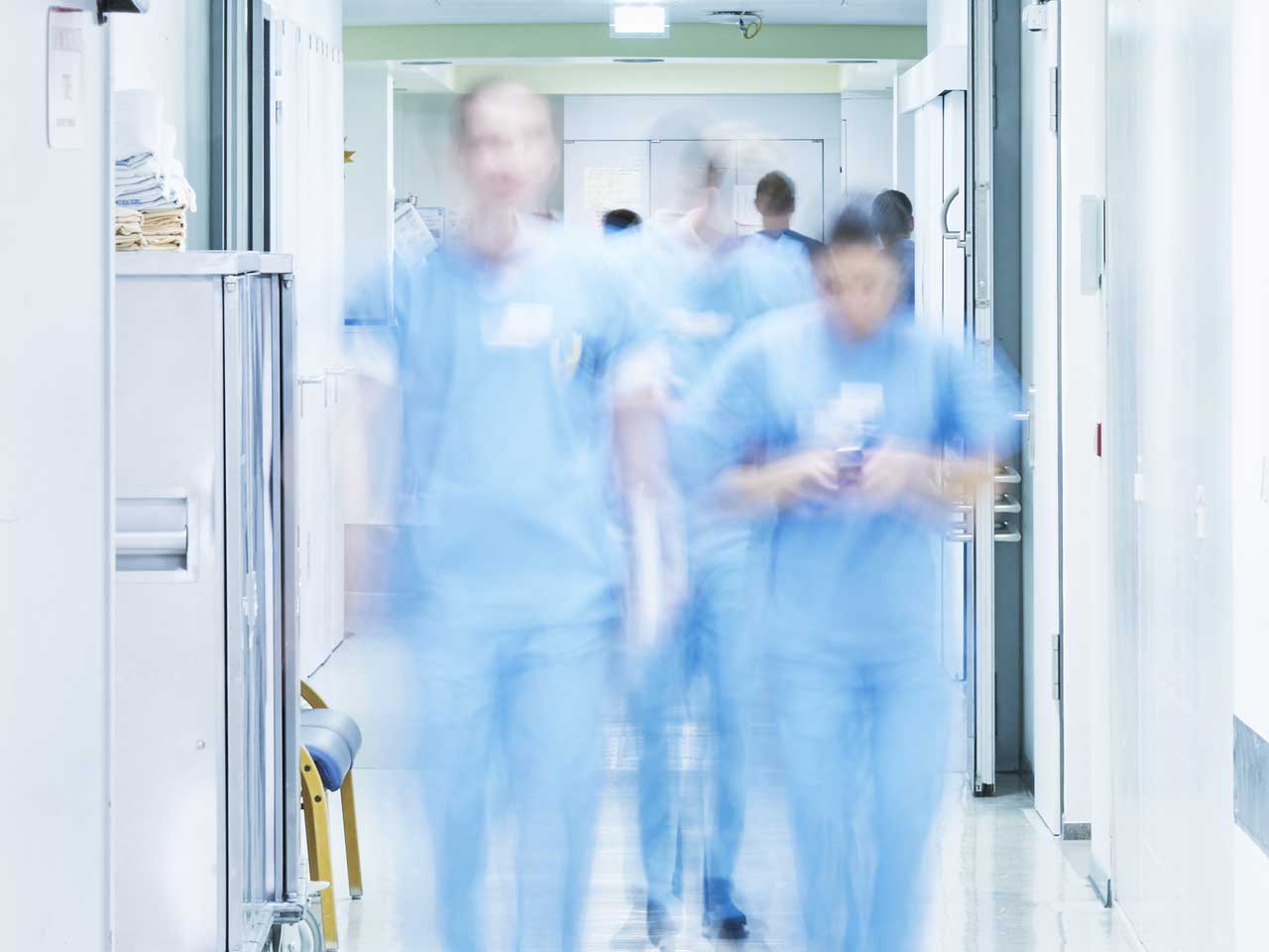 doctors walking along hospital corridor