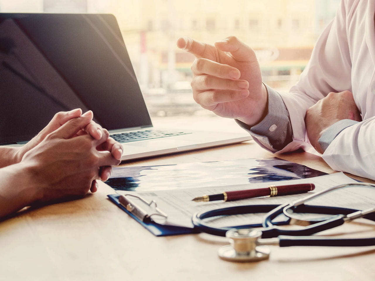Doctor and patient talking at a desk
