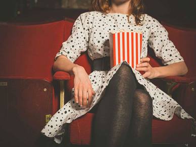 woman at cinema with popcorn