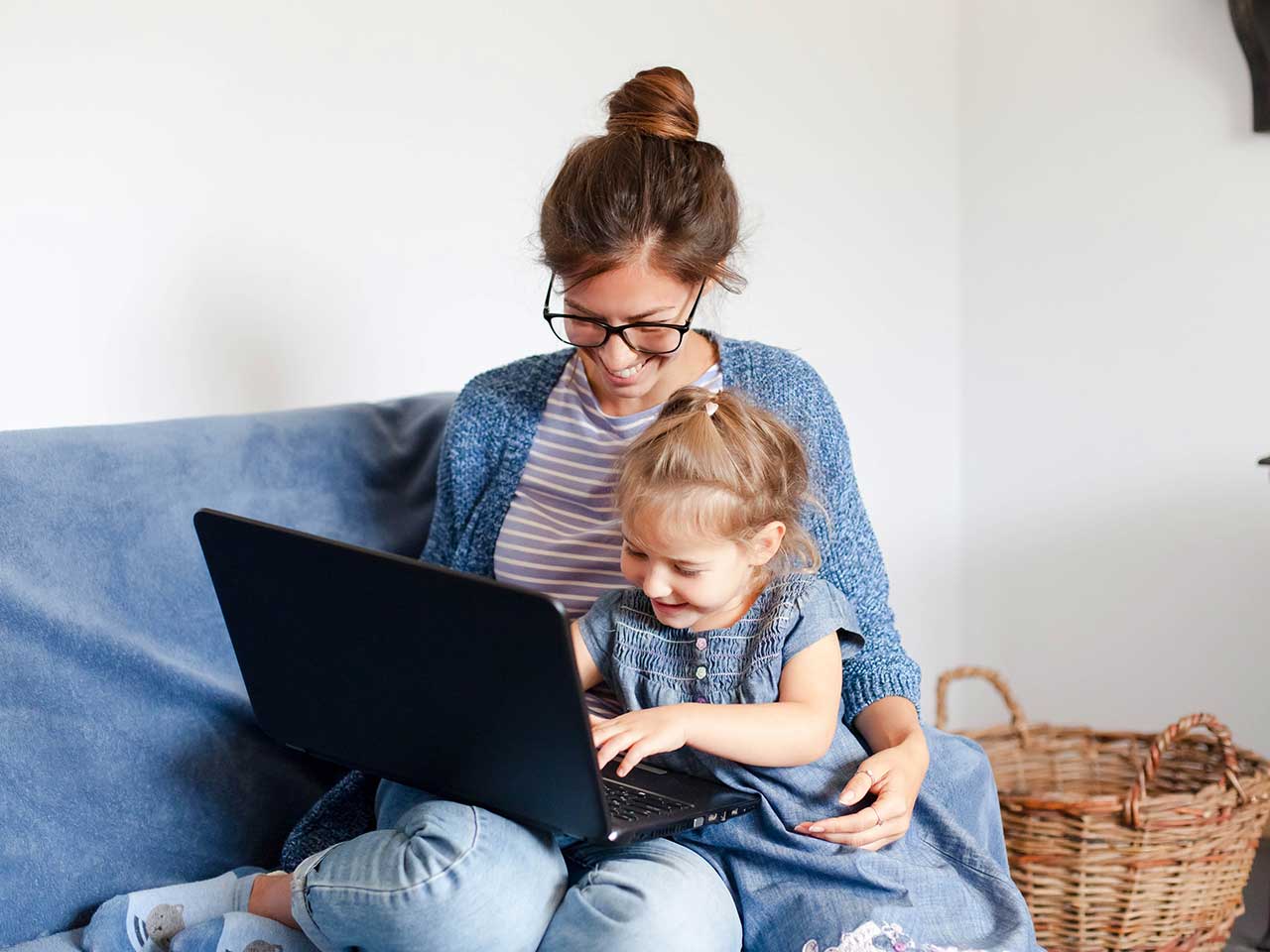 Woman with young girl on laptop