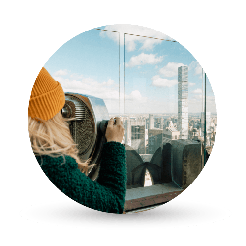 Woman using telescope in New York