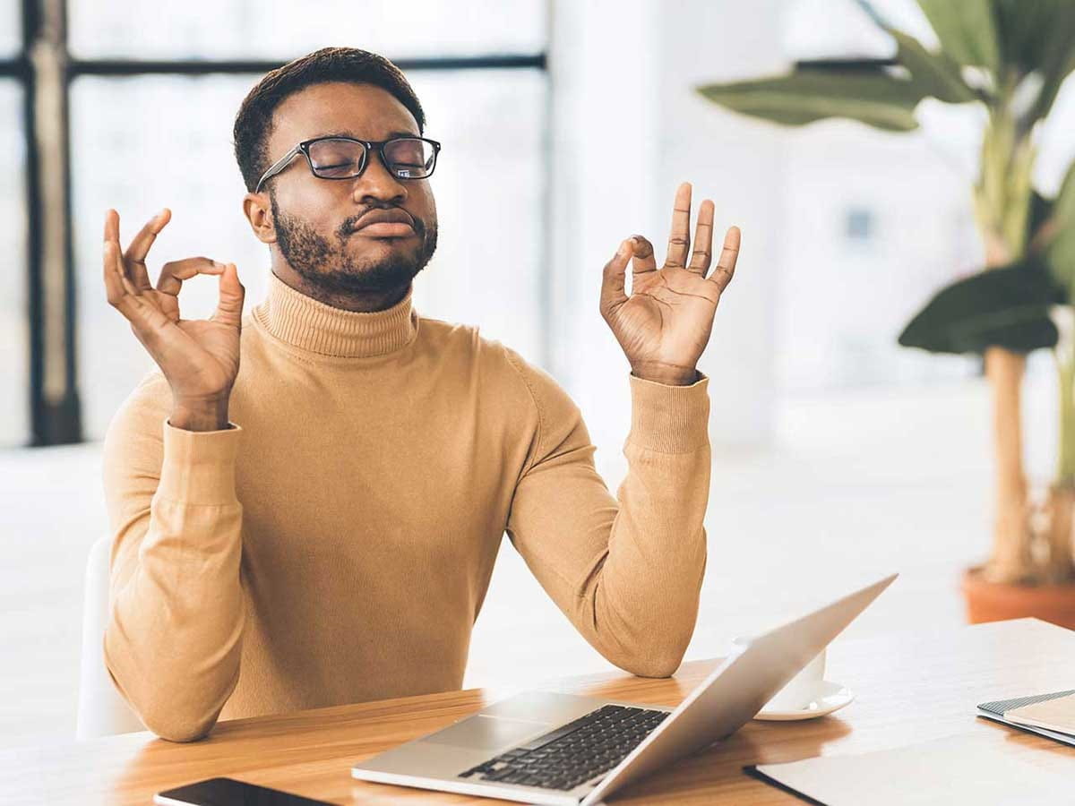 A man practicing a yoga pose at the table 