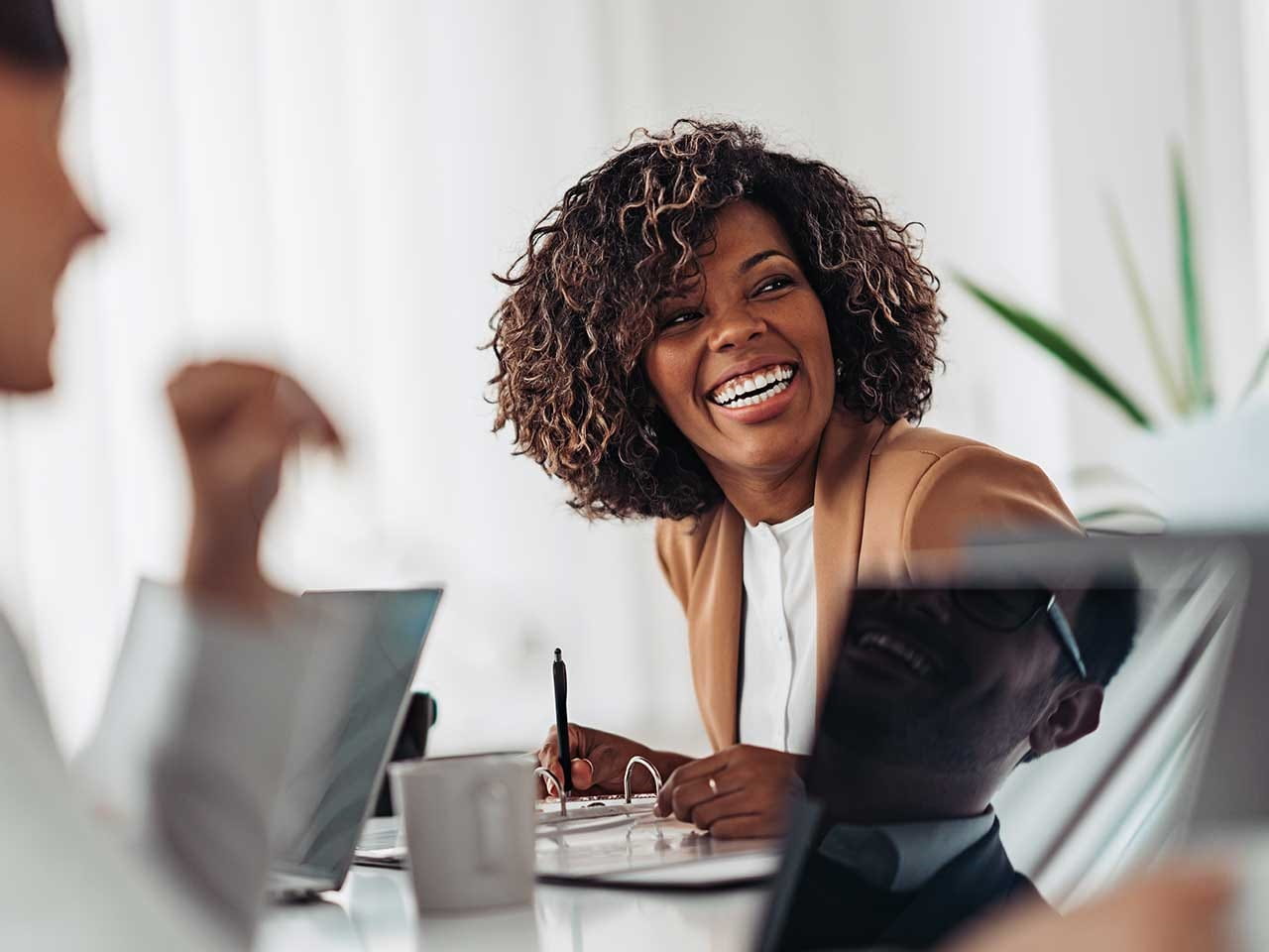 Woman laughing with her colleagues in the office
