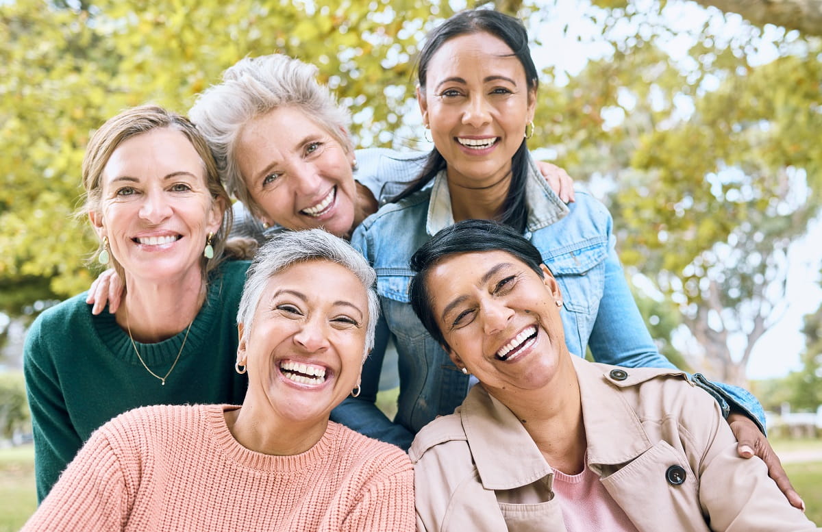 Group of women smiling in the park_1200