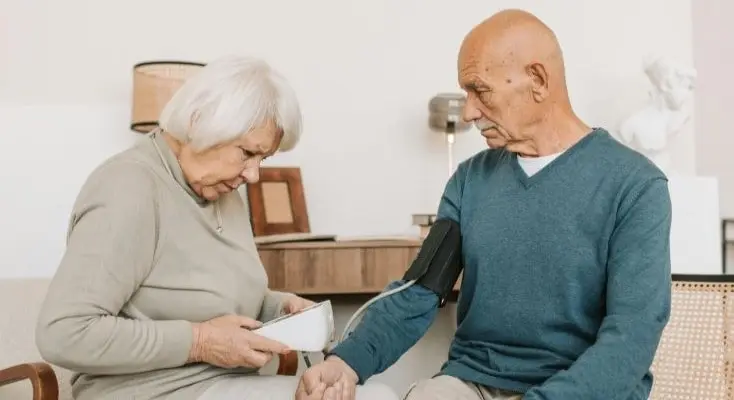 Woman Checking Blood Pressure of a Man