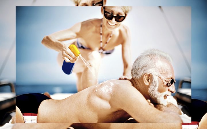 Older man and woman on beach in the sun