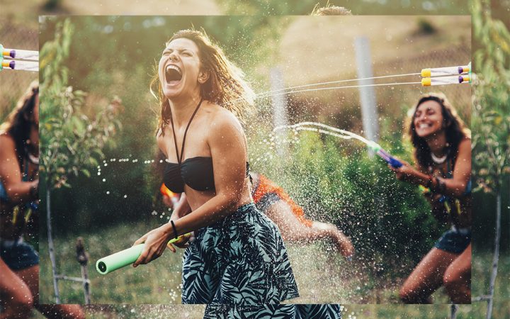 Woman and friends in garden laughing in water