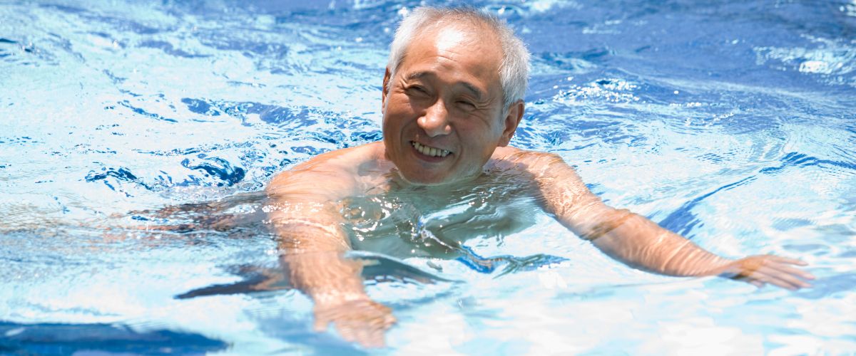 smiling old man in swimming pool
