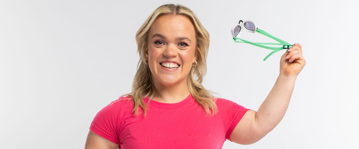 Ellie Simmonds in a pink shirt with goggles in her hand