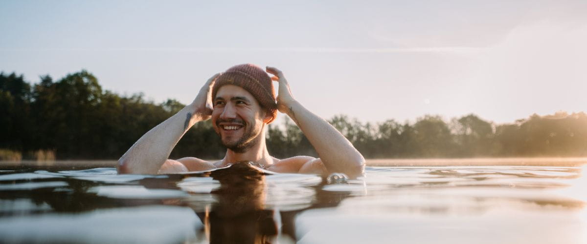 man-outdoor-swimming-with-beanie