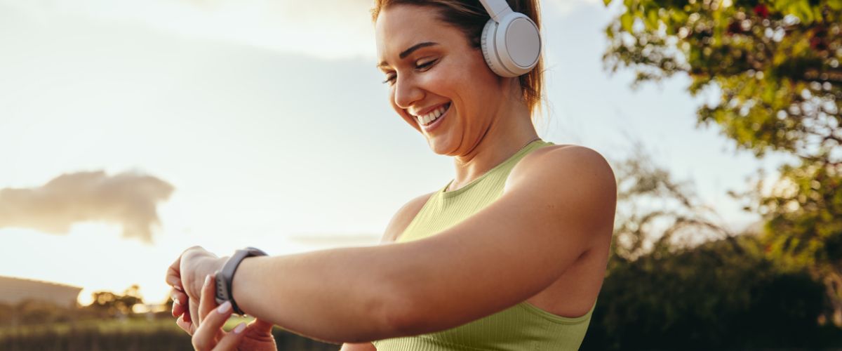 women-watch-headphones-exercise-outdoors
