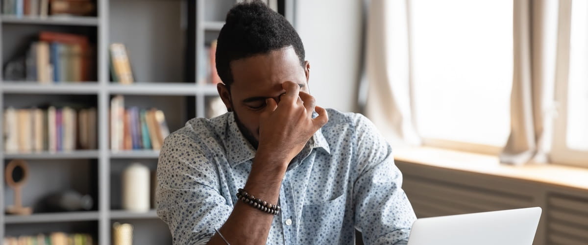 A stressed worker sitting at her desk
