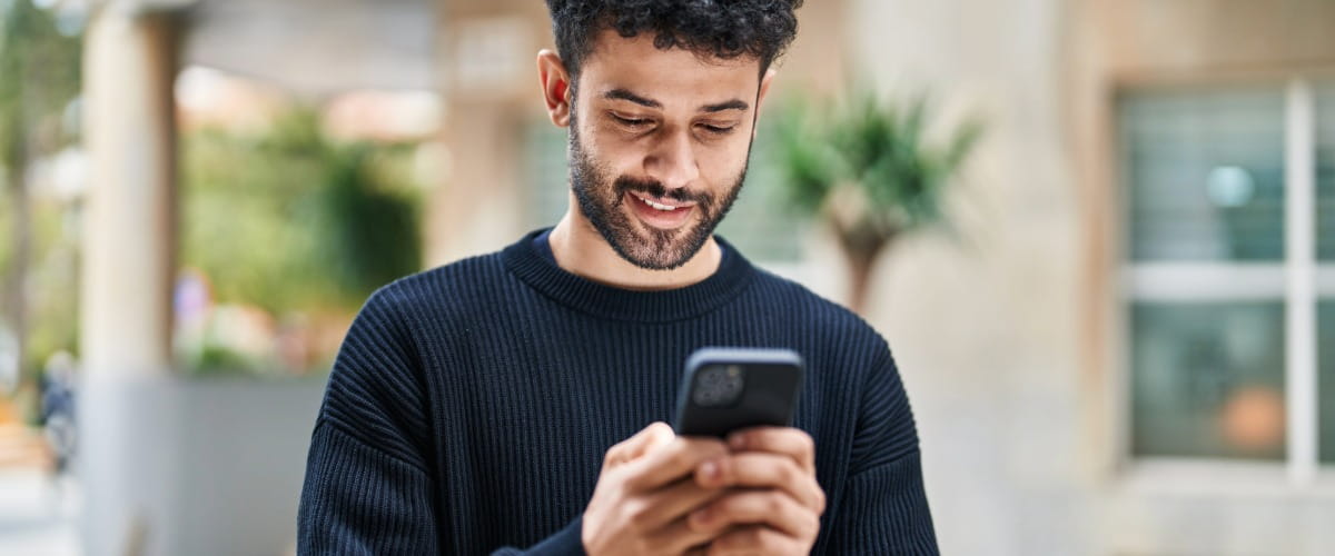 man-smiling-at-phone