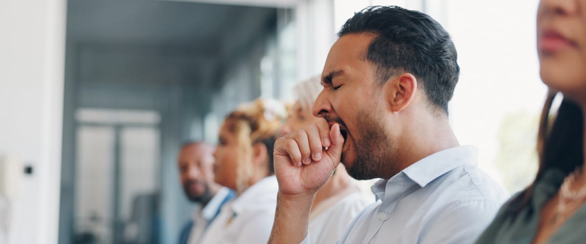 man-yawning-in-a-work-meeting
