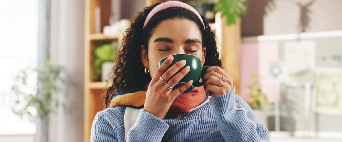 a-woman-drinking-a-hot-drink