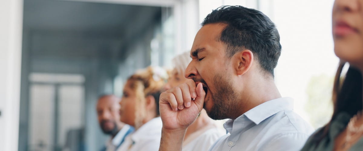 man-yawning-in-a-meeting-at-work