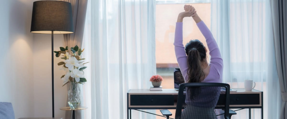 remote-worker-stretching-at-a-desk