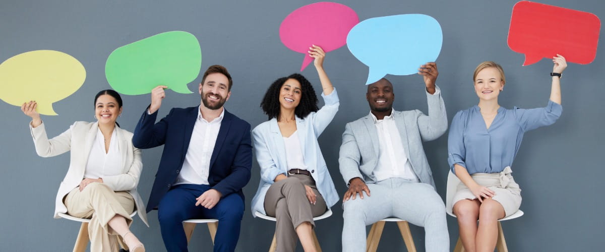 agroupofemployeesholdingupcolourfulspeechbubbles.jpg