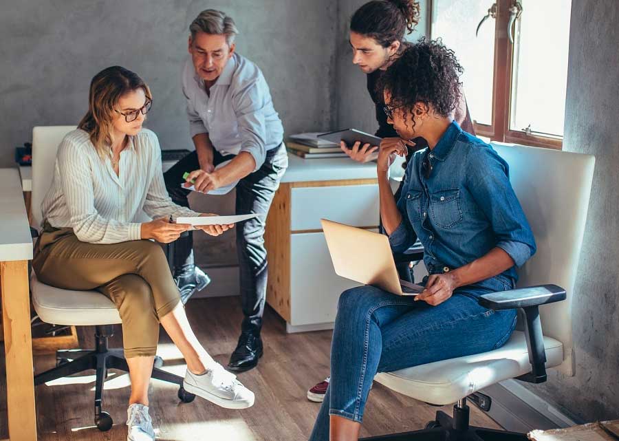 A team of four, with two men and two women, brainstorming ideas