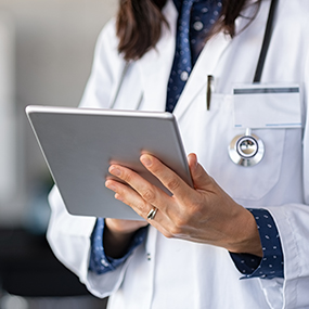 Decorative image of a doctor checking her notes