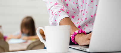 Decorative image of a mother working from home