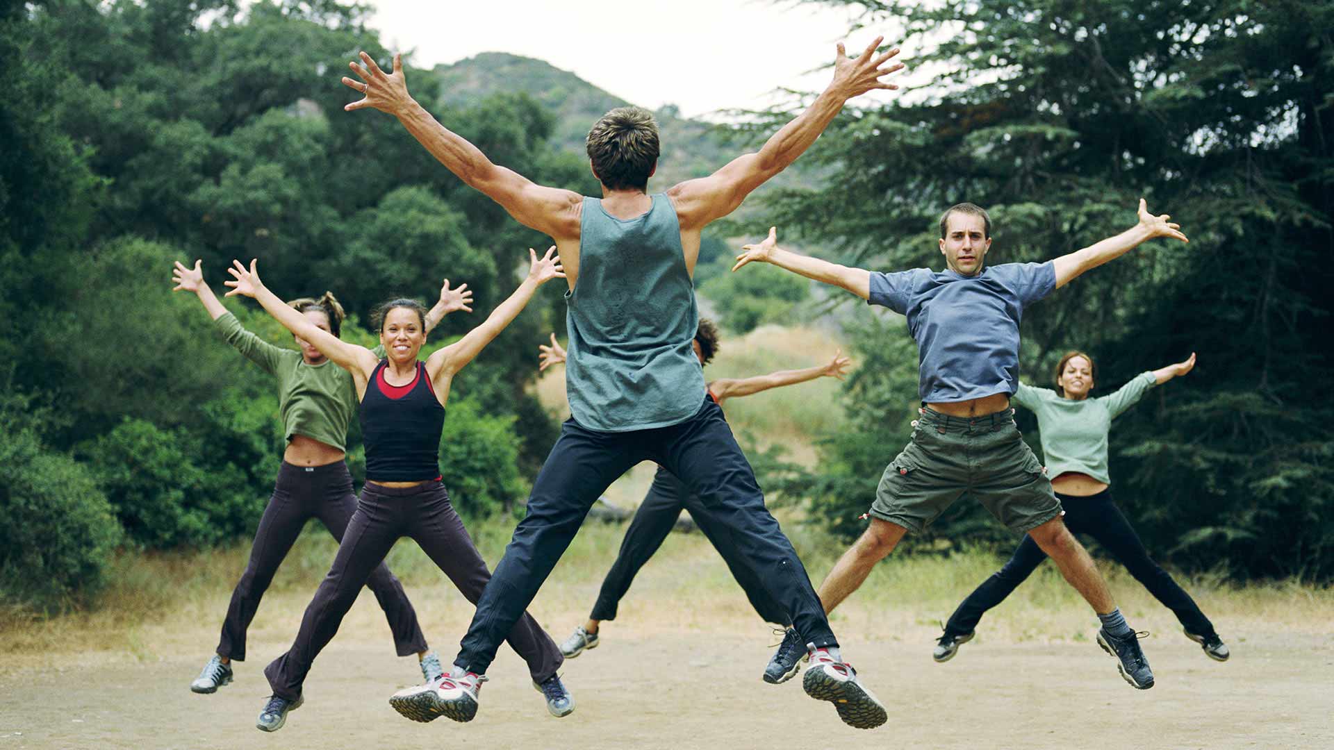 Group doing star jumps in park
