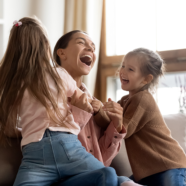 Decorate image of mother laughing with her two daughters