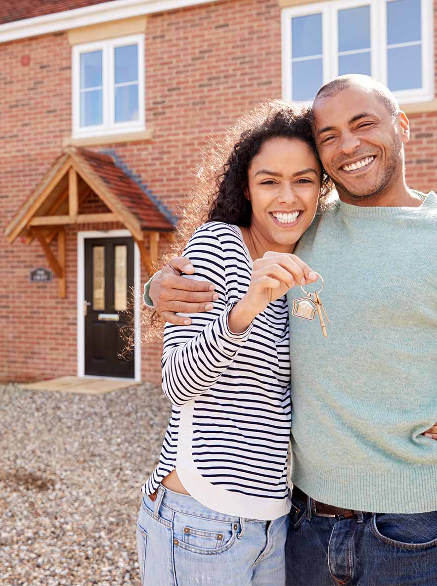 Decorate image of a happy couple outside their new home